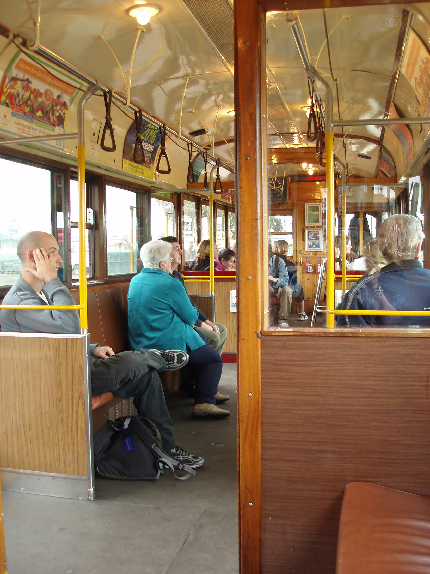an image of Random Few Seated Passenger Riding in Australian Tram in Melbourne