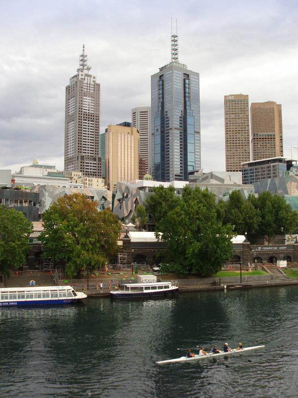 High Rise Australian Buildings in Front Yarra River with Some people enjoying rowing. Located in Melbourne