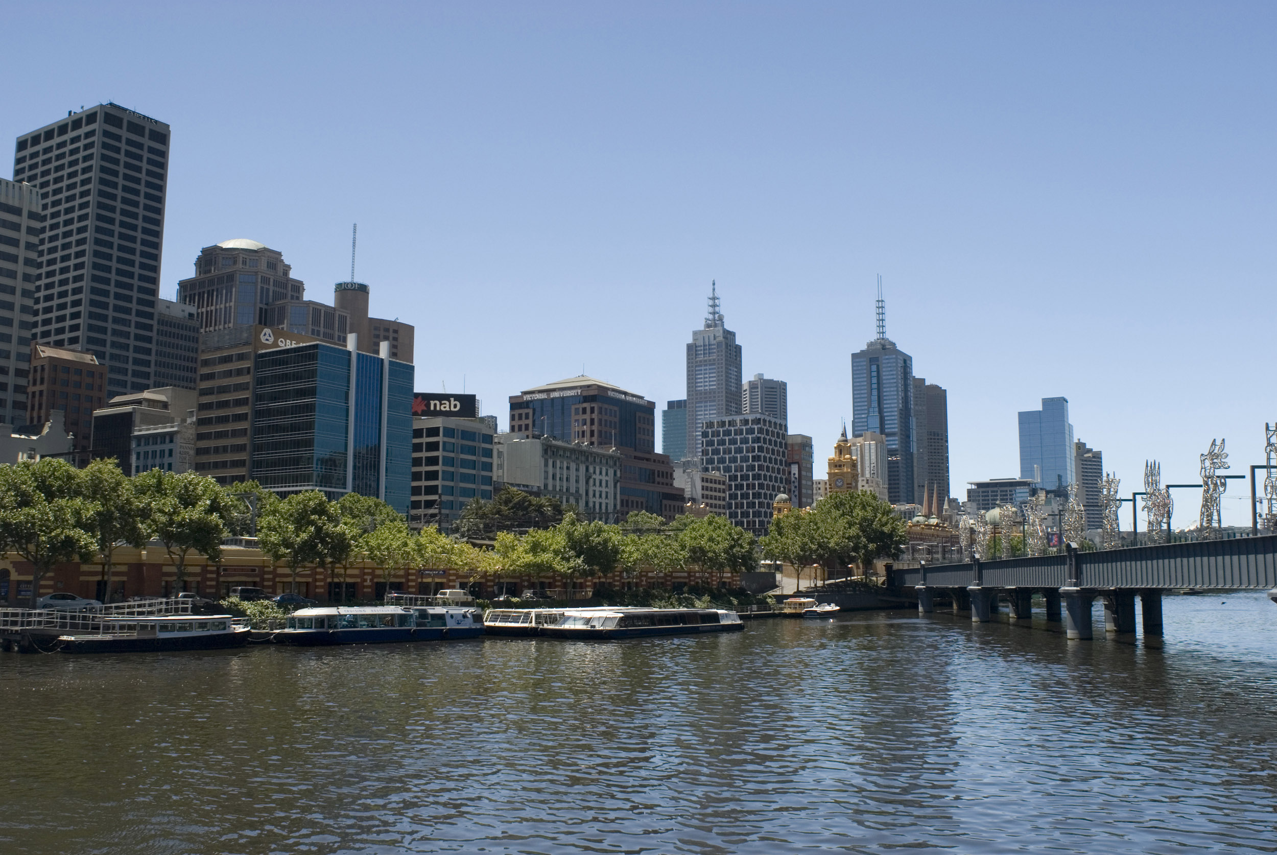 an image of A beautiful, clear, blue sunny day over the Melbourne city CBD and calm Yarra River.