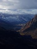 a spectacular portrait view down a valley towards coronet peak in the distance