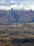 snow covered mountains viewed from coronet peak with a clear snow line below which the snow has melted