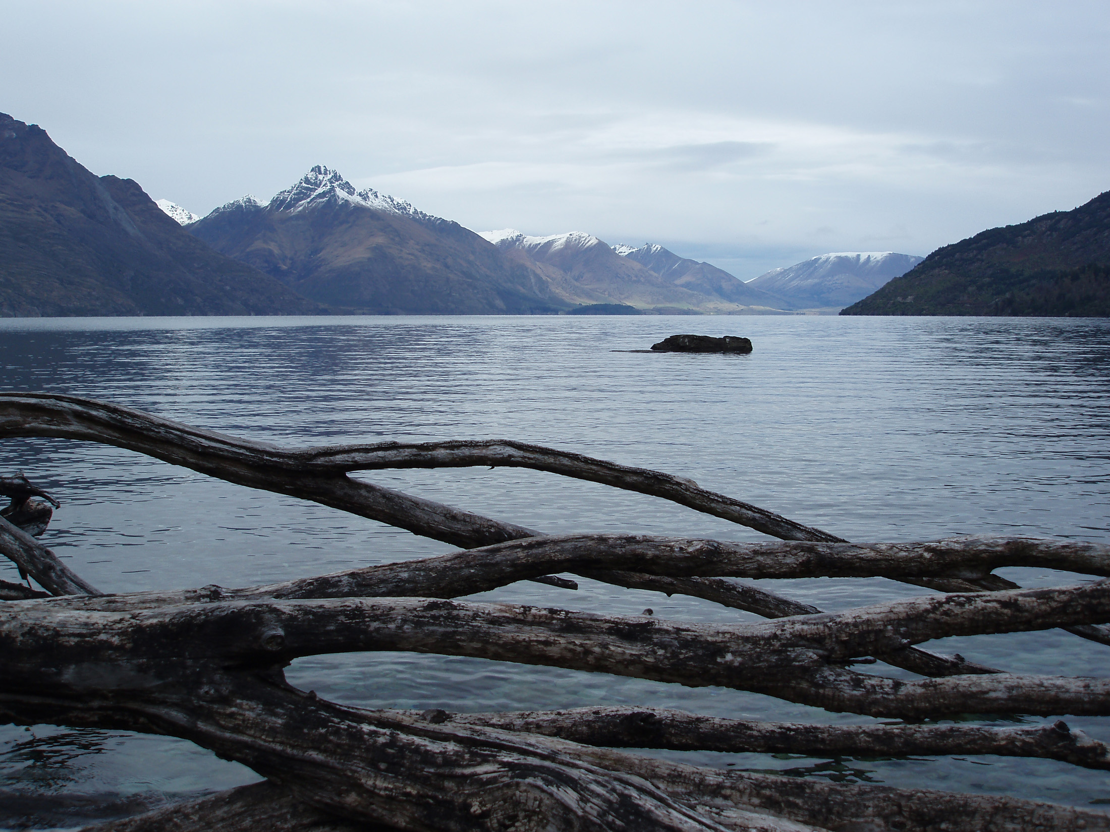 an image of spectacular mountain and lake landscape, a view across lake wakatipu, newzealand
