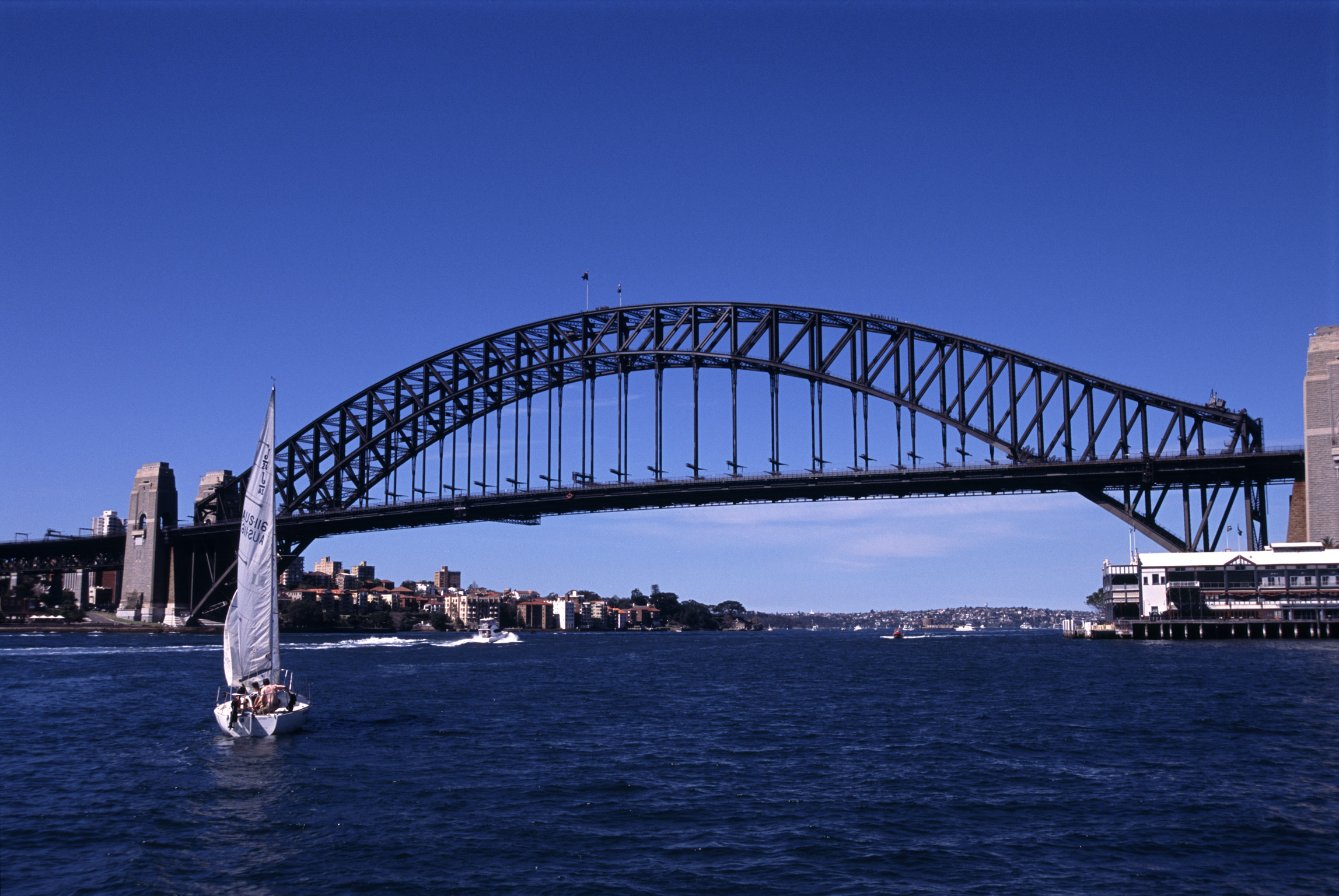 an image of Sailboat and Sydney Harbor Bridge, Sydney, Australia