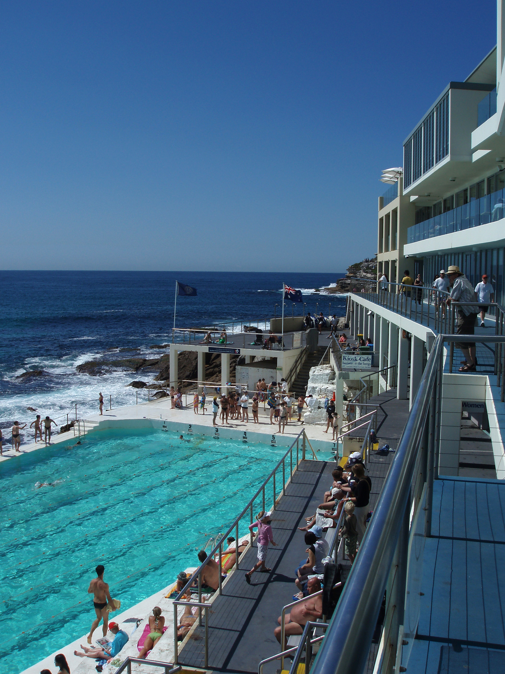 an image of Tourists at Beautiful Tidal Swimming Pool and Sydneys Famous Bondi Beach in Australia. Captured with Blue Sky Background.