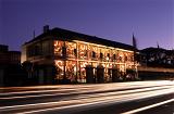 Streaking Lights Passing Building Illuminated with Christmas Lights at Night, Sydney, Australia