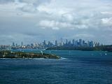 Sydney, Australia, skyline viewed across the water of the harbour with its modern architecture and tall skyscrapers under a cloudy sky