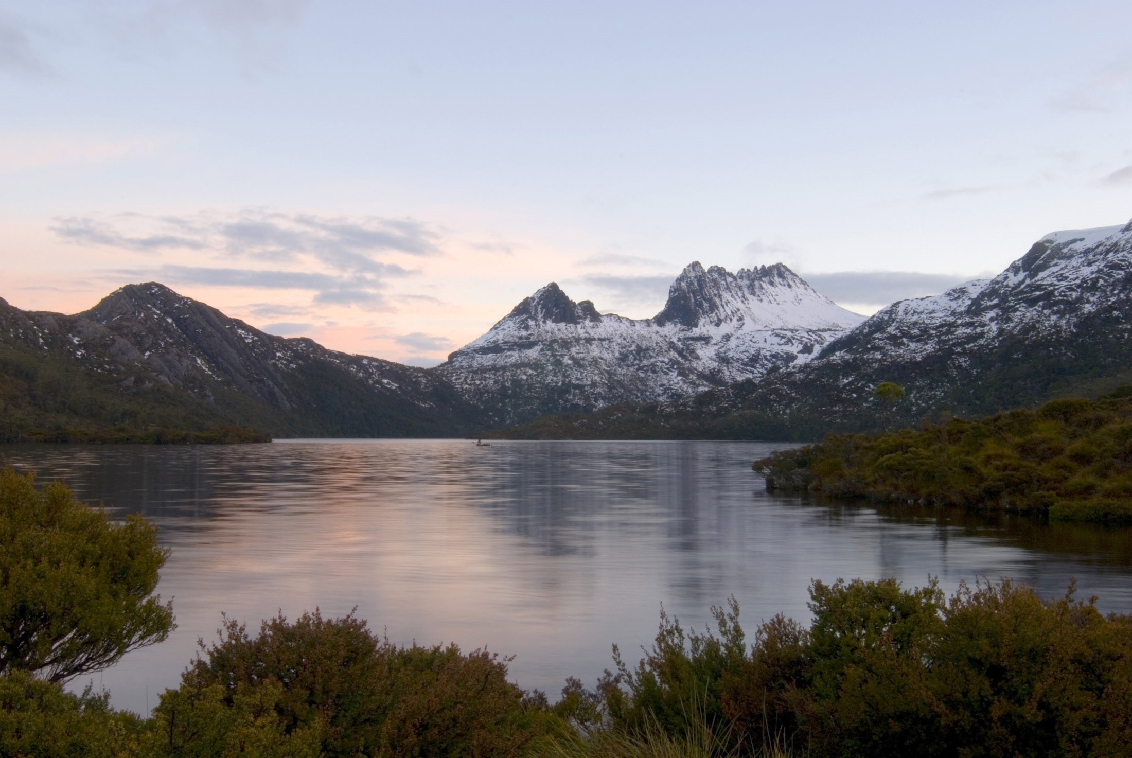 an image of sunset over dove lake, a snow covered cradle mountain in the background