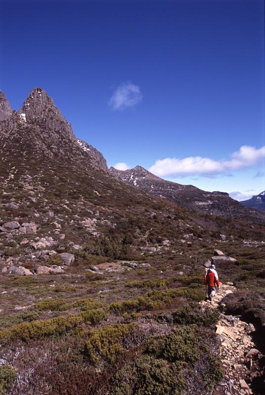 Tourist Exploring at Famous Mount Ossa, the Highest Mountain in Tasmania, Under Blue Sky. It lies in the heart of Cradle Mountain-Lake St Clair National Park.
