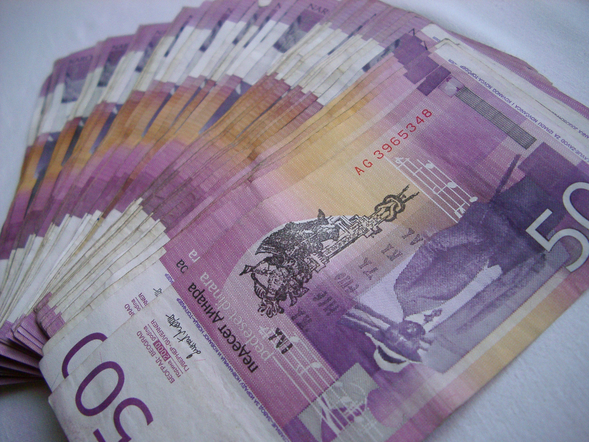 an image of Background of Yugoslav banknotes fanned out in a receding line away from the camera