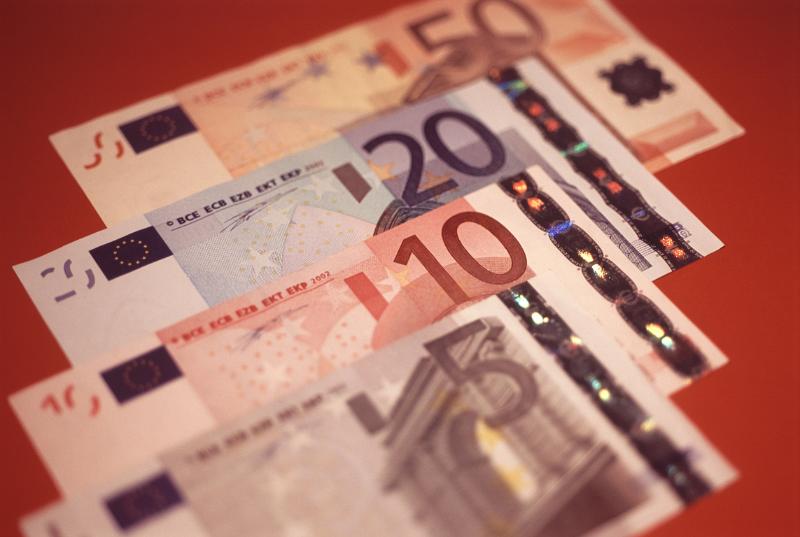 Background of euro banknotes arranged in an overlapping receding row with different denominations visible