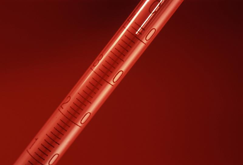Close Up of Red Hot Thermomter on Red Background, Studio Shot