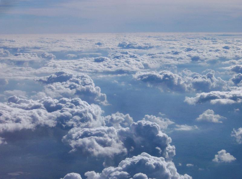 Overview of Puffy Clouds in Blue Sky as if Shot from Airplane