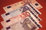 Background of euro banknotes arranged in an overlapping receding row with different denominations visible
