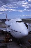Preparing Airplane for Take Off on Tarmac at Airport with Boarding Bridge Attached