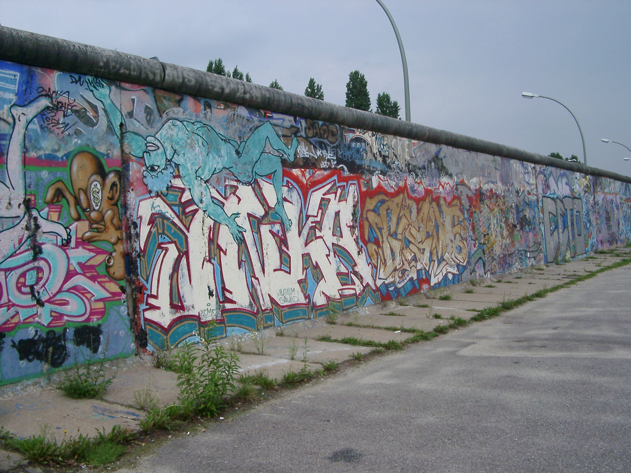 an image of Section of the Berlin Wall in East Germany erected during the Cold War to separate the city covered in colorful urban art or graffiti