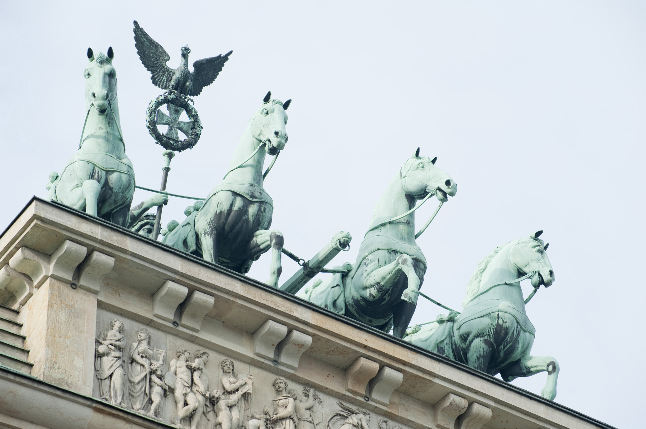 an image of chariot drawn by four horses driven by Victoria, the Roman goddess of victory on top of the Brandenburg gate. Berlin Germany