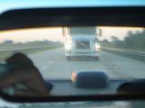Blurred Transport Truck in Rearview Mirror as seen from Driver Perspective