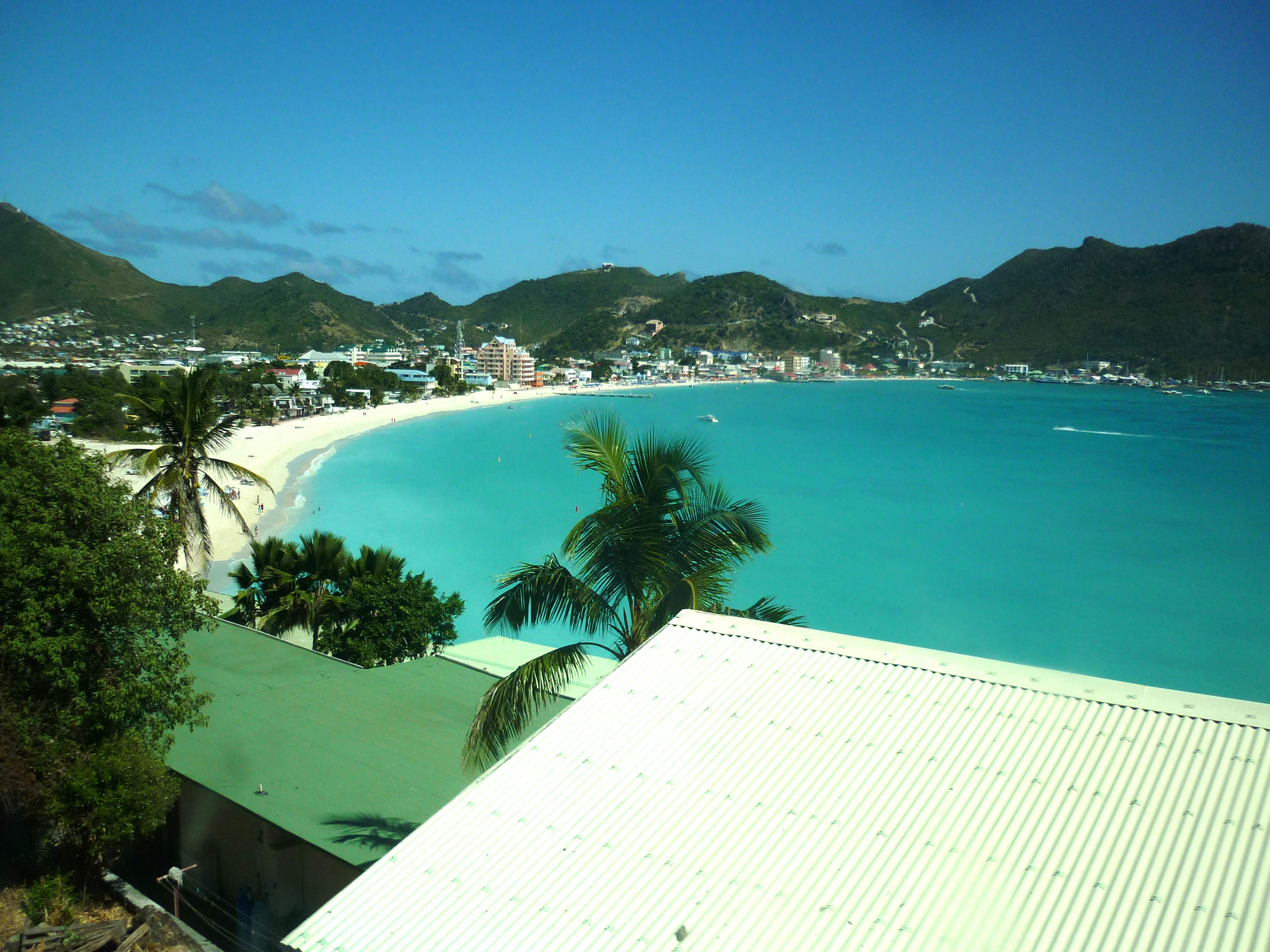 an image of looking across a golden sandy beach on the island of st martin