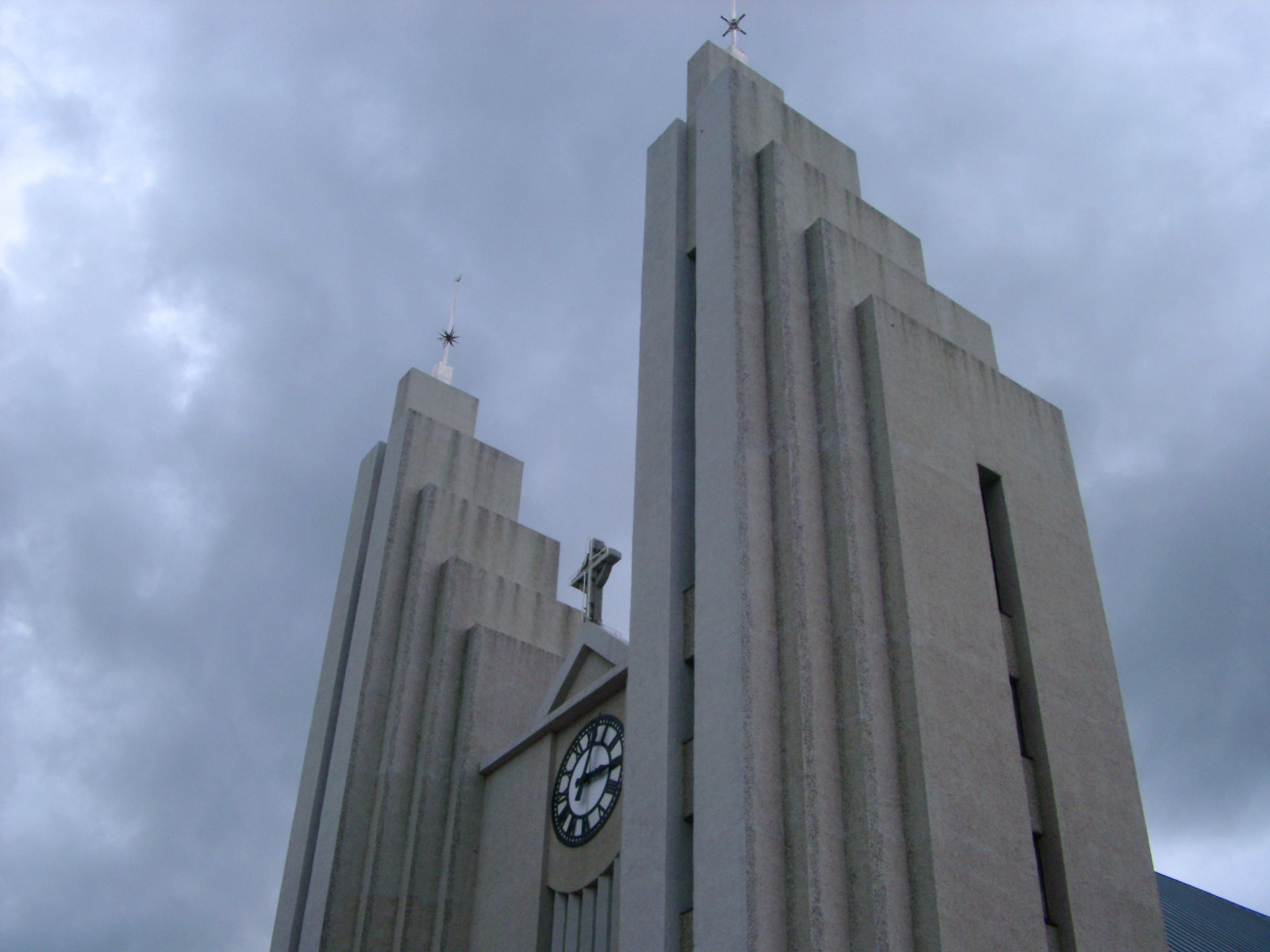 an image of Looking Up at Modern Akureyi Church Against Forboding Storm Clouds