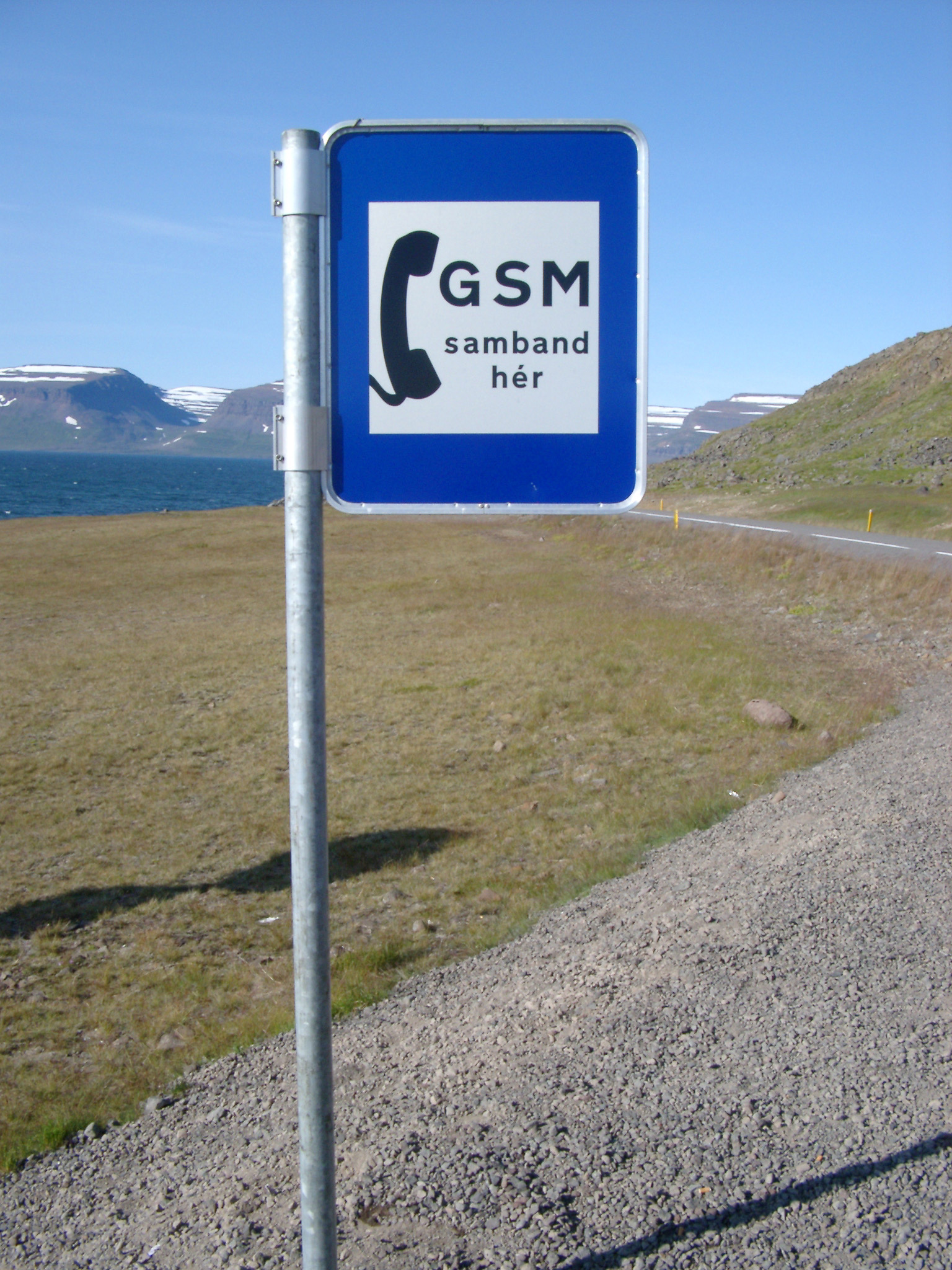 an image of Mobile phone point with a sign indicating that their is a GSM signal available at this point at the side of a remote road in Iceland