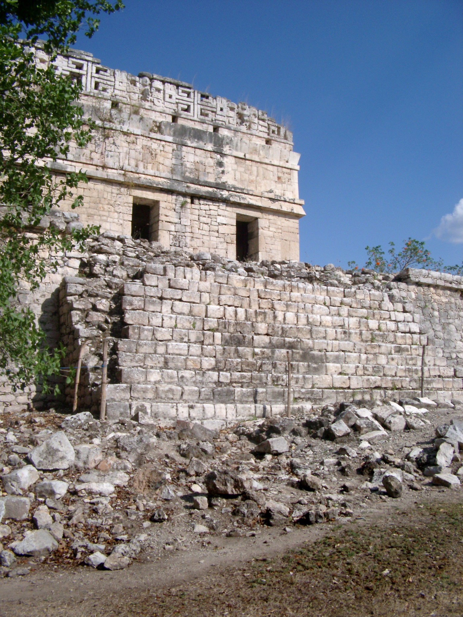an image of Ancient Disfigured Building Structure at Chichen Itza. Isolated on Blue Sky Background.
