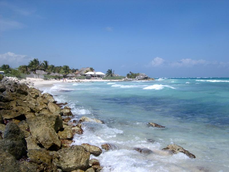 Big Rocks at Seashore at a Beautiful Mexican Beach. Captured in Extensive View. Isolated on Light Blue Sky Background.