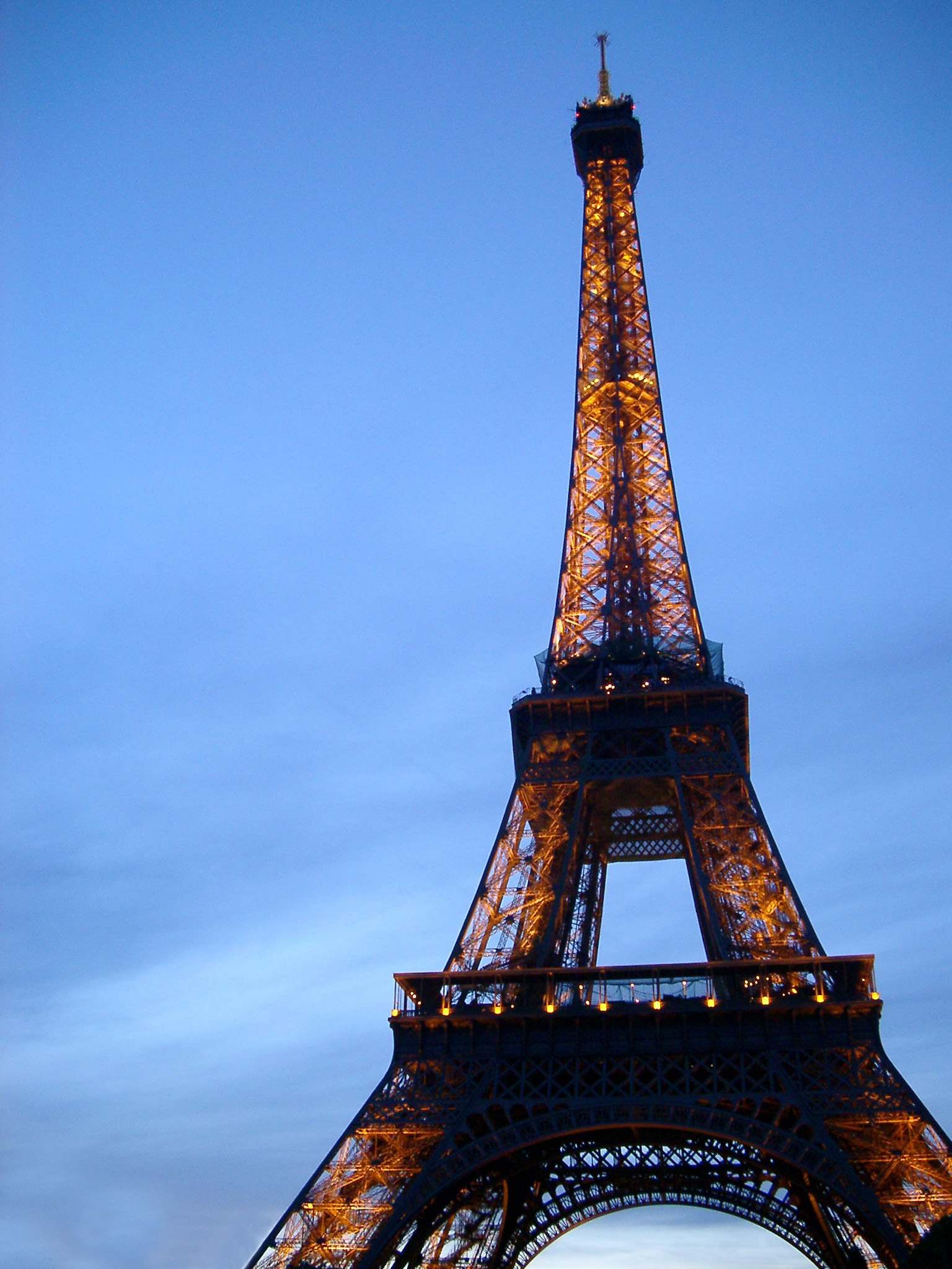 an image of Close up view looking up of the iconic Eiffel Tower, Paris against a clear sunny blue sky with copyspace in a travel concept