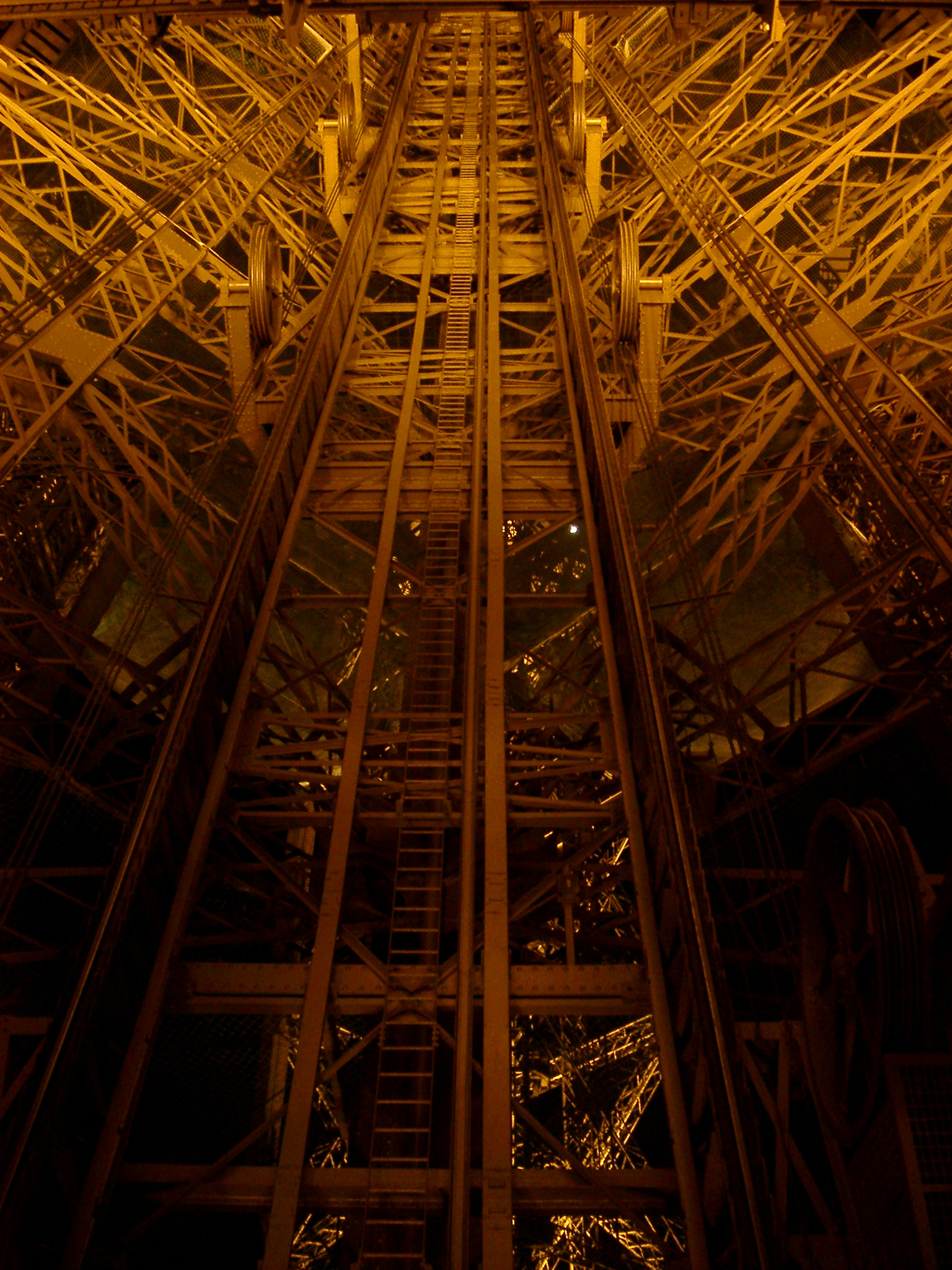 an image of Famous Eiffel Tower Sculpture in Worms Eye View. The Most- Visited Paid Monument of the World. Captured at Night Time.