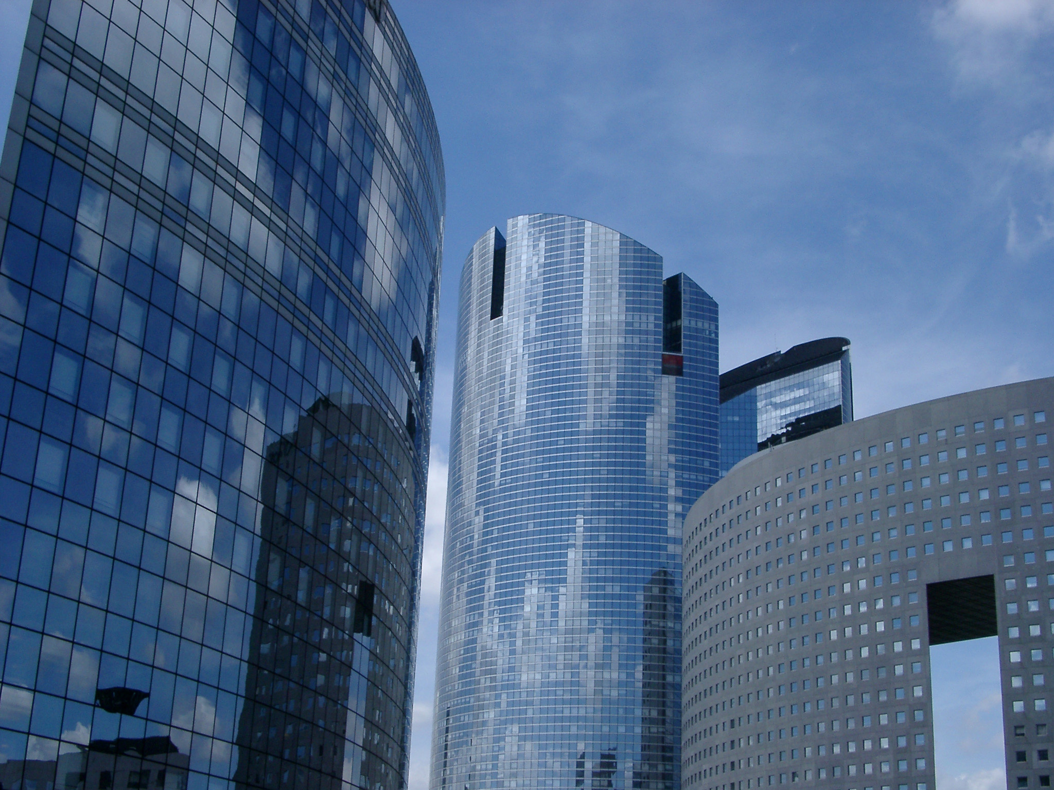 an image of Close up Modern Architectural High Rise Buildings in Paris. Isolated on Light Blue Sky Background.