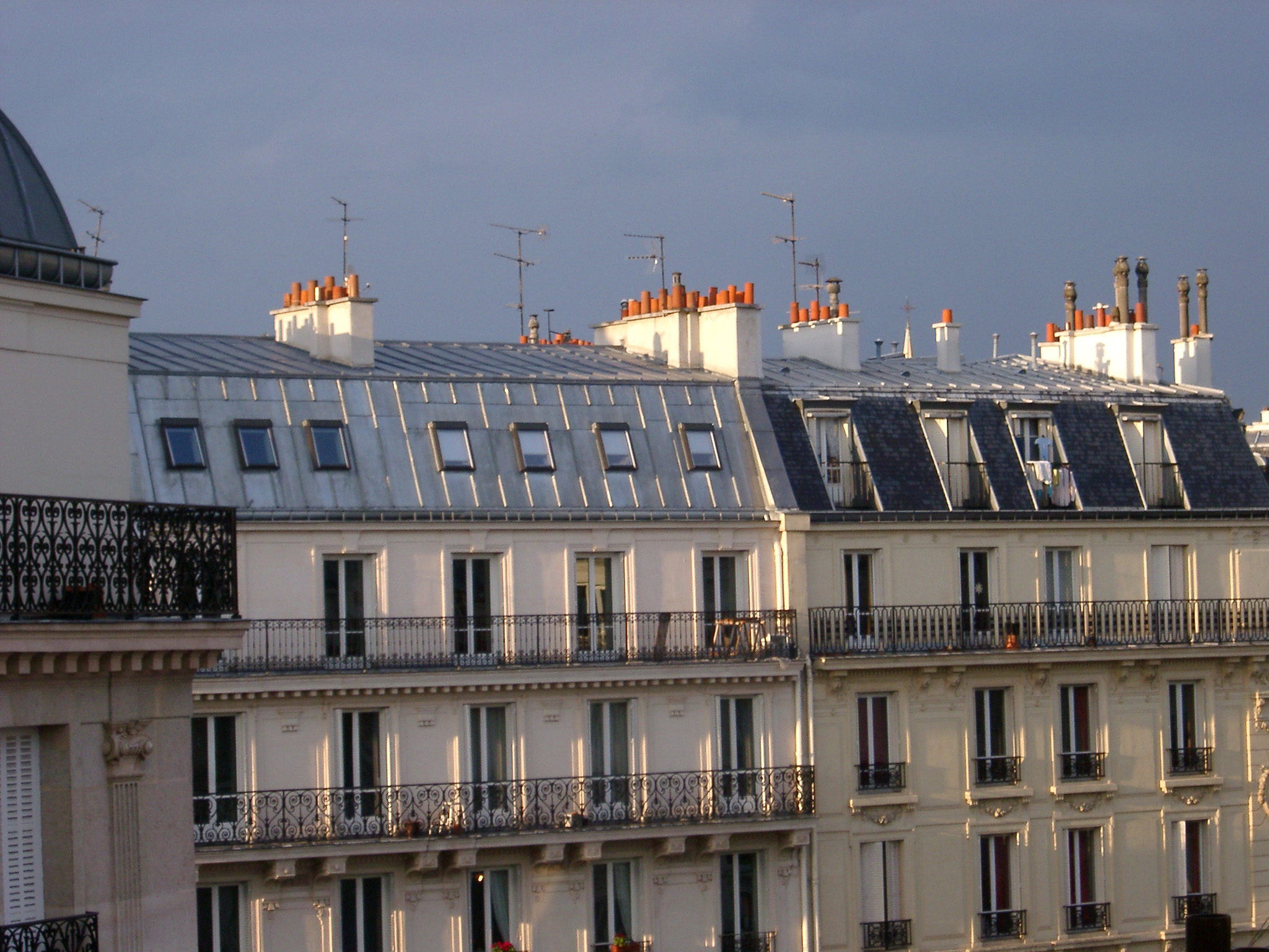 an image of Paris Building Rooftops in Warm Sunlight in Late Afternoon or Early Morning