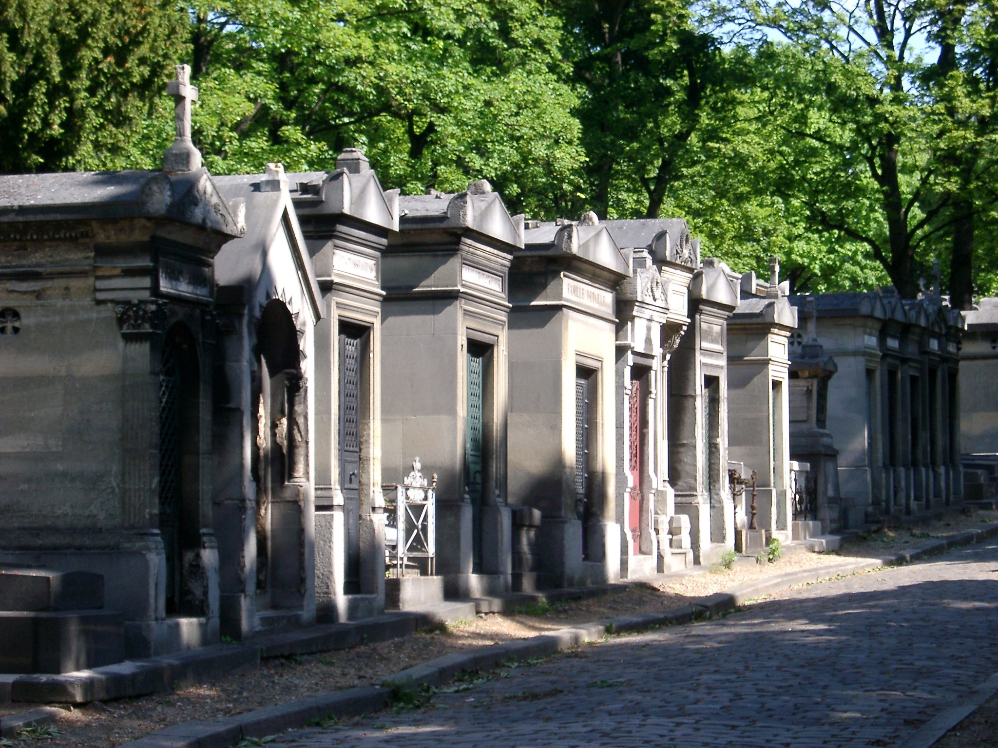 an image of old stone crypts at pere-lechaise cemetery