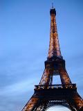 Close up view looking up of the iconic Eiffel Tower, Paris against a clear sunny blue sky with copyspace in a travel concept