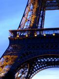 Detail of the lattice framework and iron girders of the Eiffel Tower, Paris against a blue sky