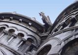 Old Vintage Gargoyle Sculpture on the roof of sacre coeur, Isolated on Light Blue Sky Background.
