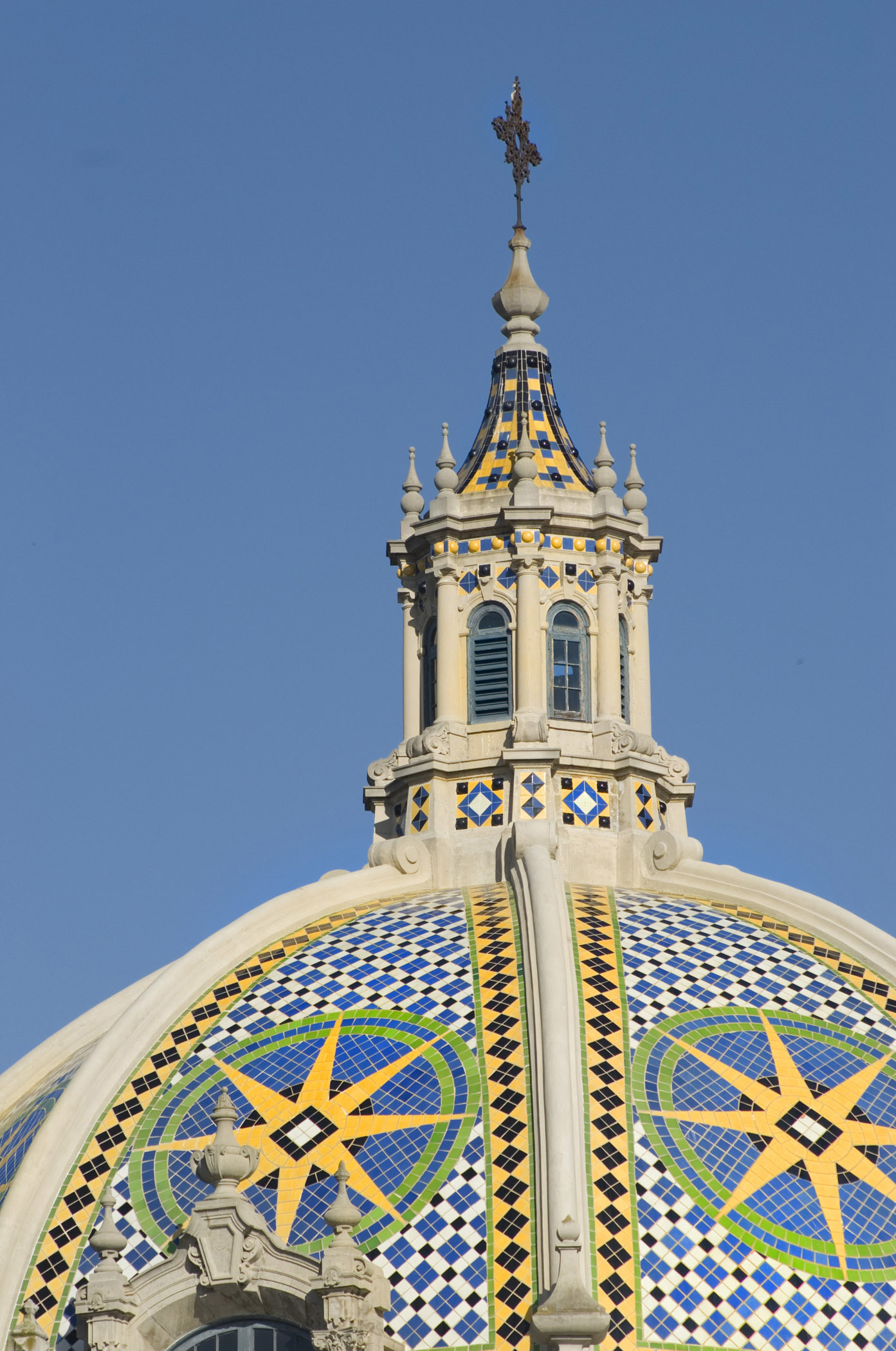 an image of Close up Artistic California Dome with Mosaic Tiles at Balboa Park San Diego. Isolated on Blue Sky.