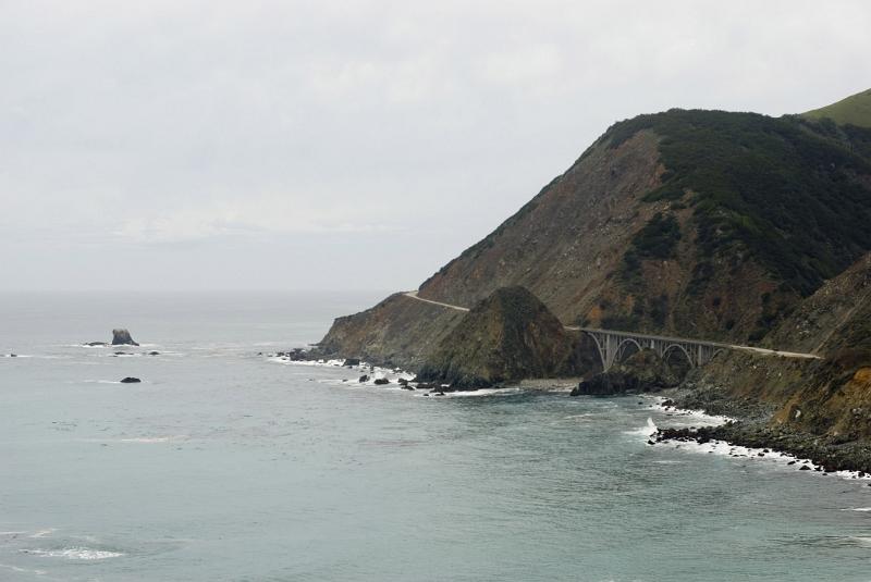 Rocky Big Creek Bridge at Beautiful Big Sur Coast Portrait. Isolated on Lighter Gray Sky Background.