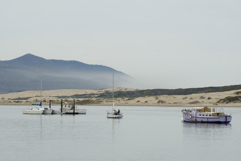 Small Fishing Boats at Beautiful Morro Bay. Captured in Extensive View with Mountain at Far Distant.