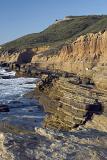 Beautiful Cabrillo Coast Tourist Attraction at San Diego. Captured with Grassy Hill Along the Sea. Isolated on Light Blue Sky Background.