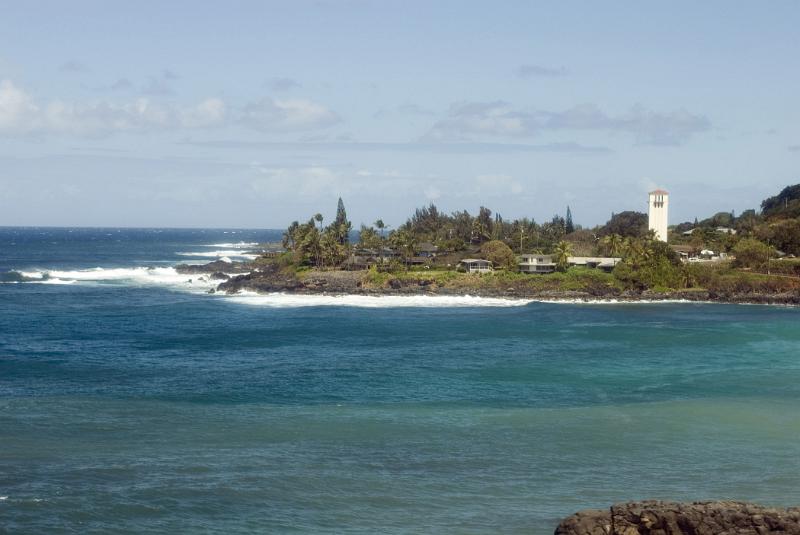 Perfect Vacation Destination - Waimea Beach Park in Hawaii. Captured in Extensive View on Lighter Blue Gray Sky Background.