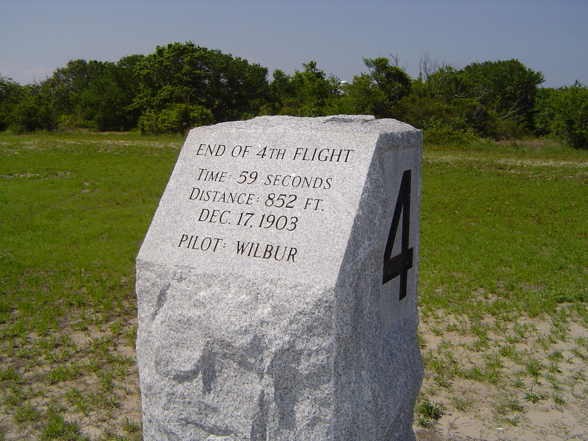 an image of Kitty Hawk memorials with a marker for the fourth flight by Wilbur and Orville Wright showing the duration and distance