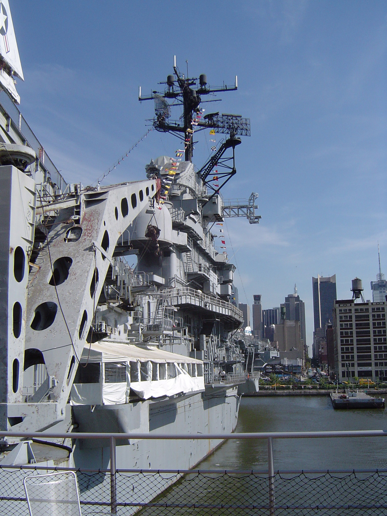 an image of Vintage Huge Gray Naval Ship on Water Isolated on Light Blue Sky Background.