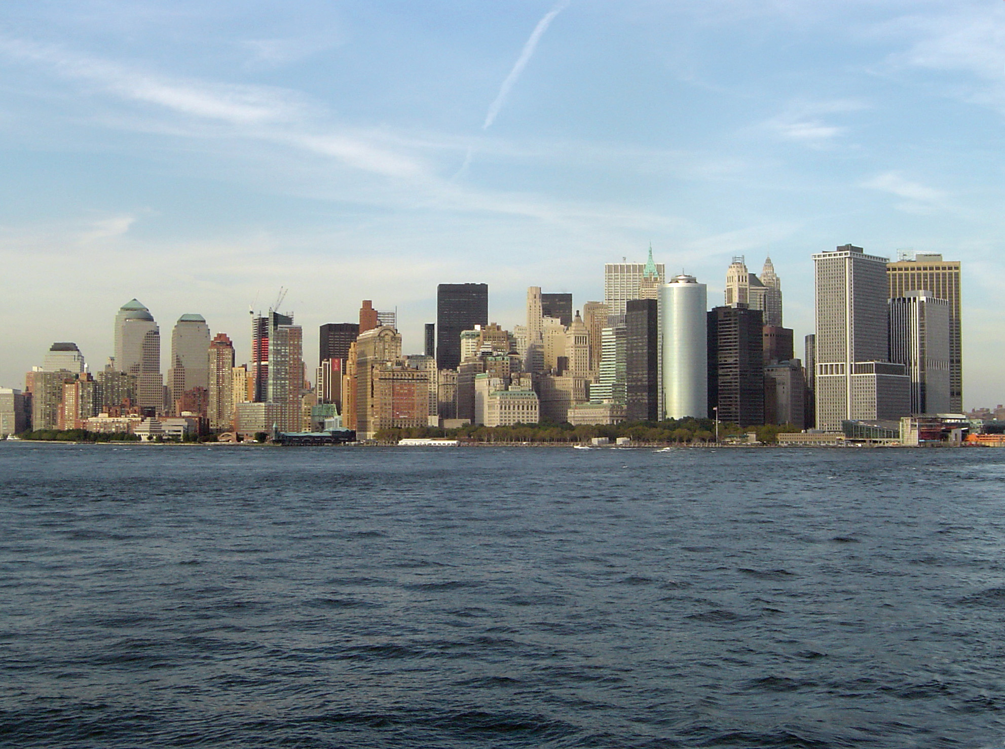 an image of Manhattan, New York, USA, skyline with its modern skyscrapers viewed across the water from the ferry