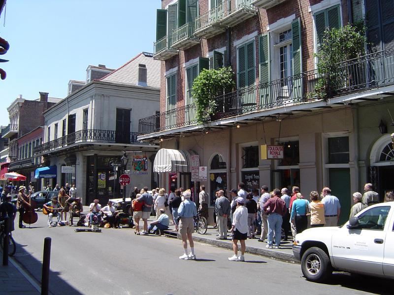 Random Busy People at City Street of New Orleans. Captured Concrete Buildings Portrait.