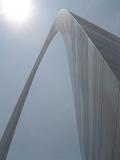 View looking up the curve of the Gateway Arch, St Louis, USA against a blue sky with sunburst