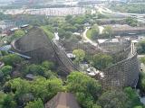 Aerial view of a roller coaster ride in a theme park in the USA set amongst leafy green trees for that ultimate thrill