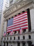 Big American Flag on Old Vintage Architectural Building at Wall Street in New York.