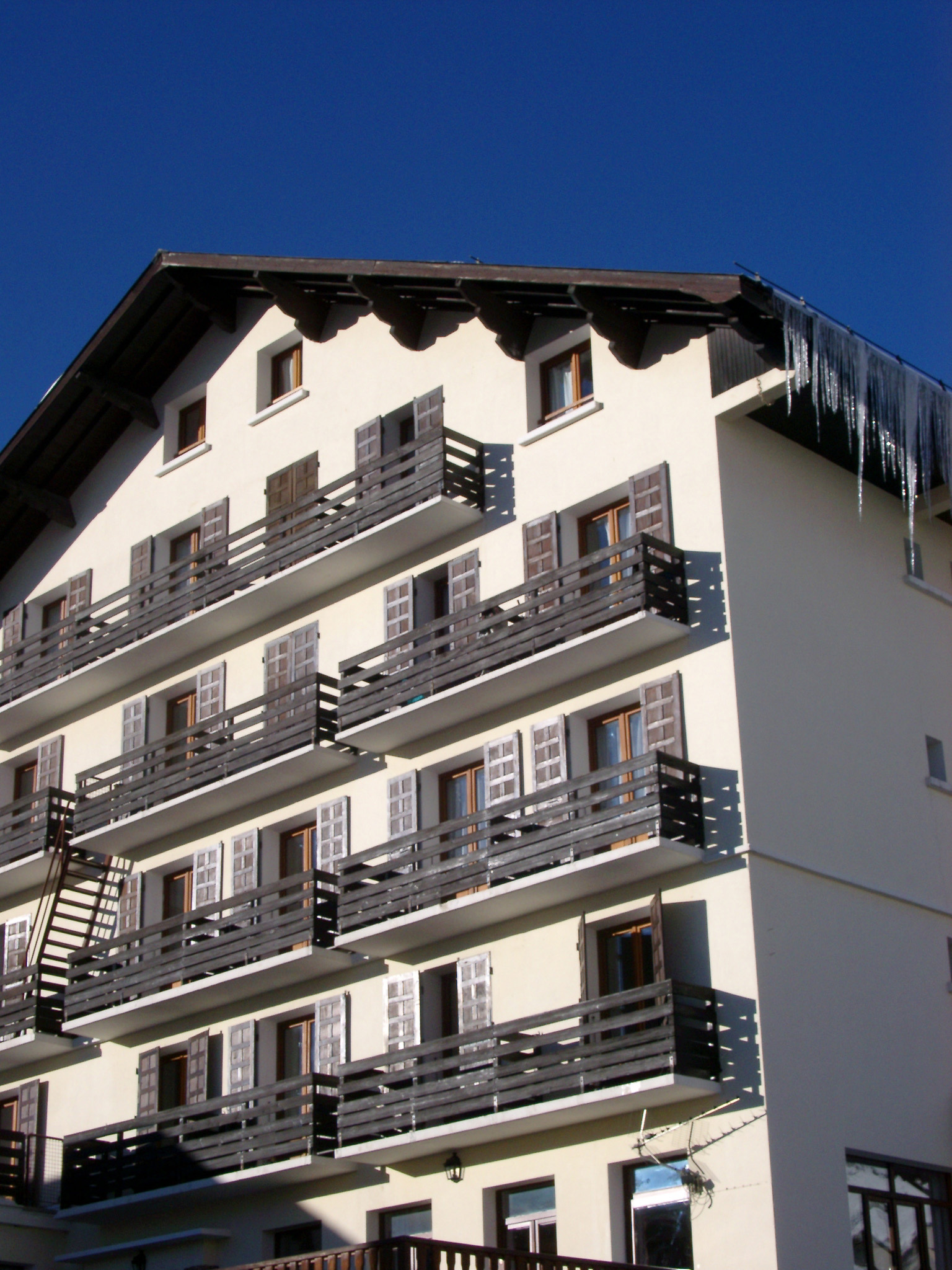 an image of Architectural Alpine Lodge Building Exterior Design on Blue Sky Background.