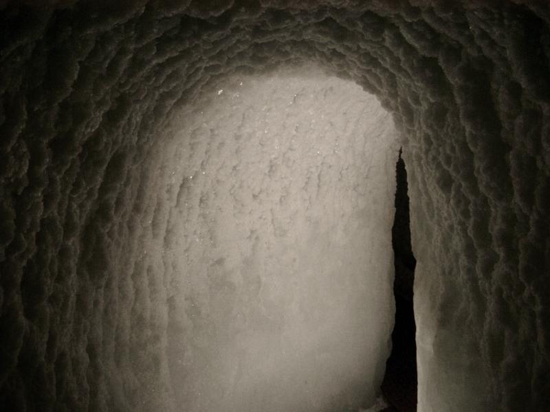 Carved arched tunnel under the ice in the Ice caves in the Alps forming a grotto for tourists to visit