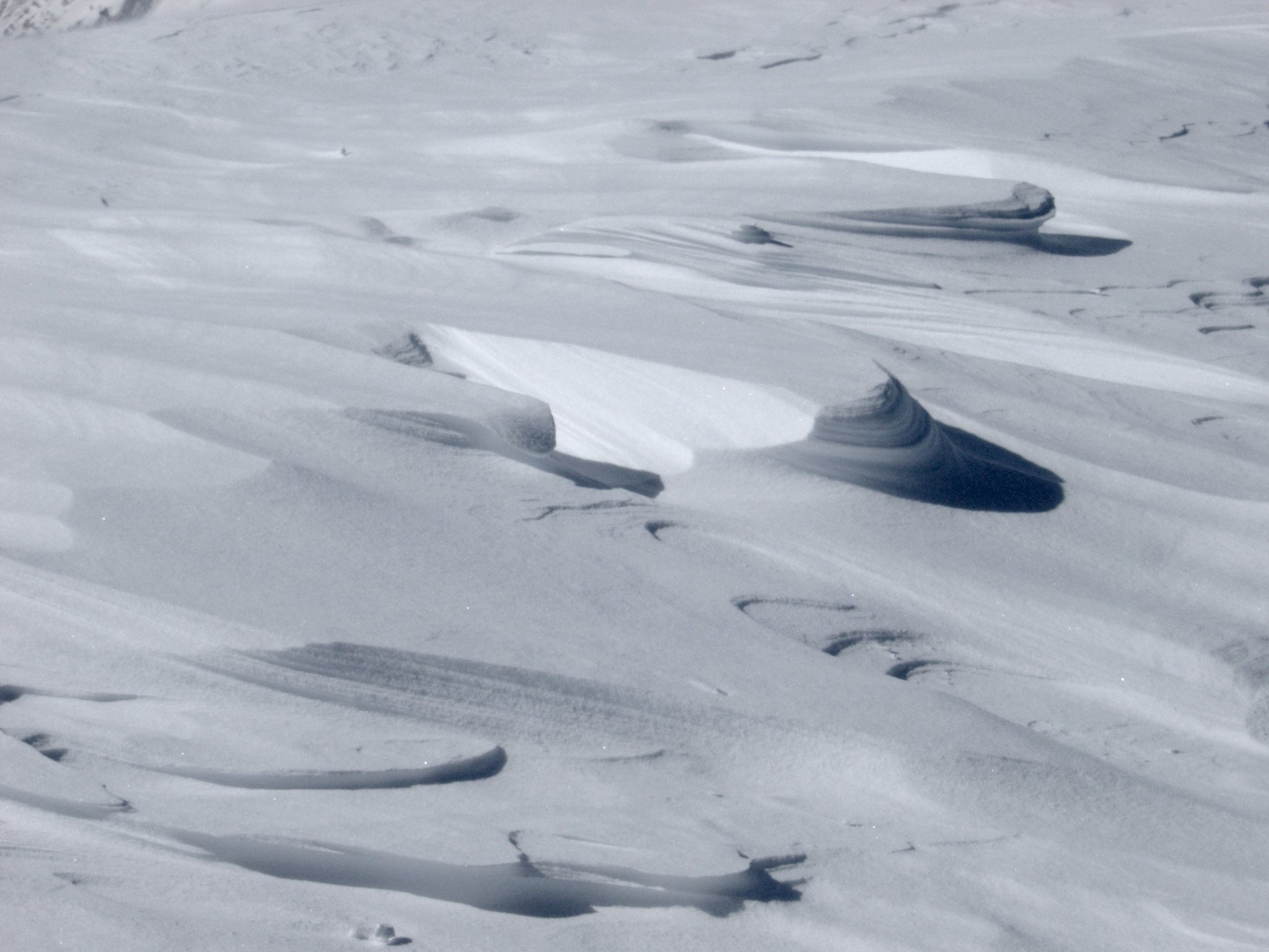 an image of Wind Blown Sand-like Ice Snow on the Field During Winter Season.