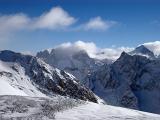 Snow Covered Mountains in France During Winter Season. Captured on Lighter Blue and White Sky Background.
